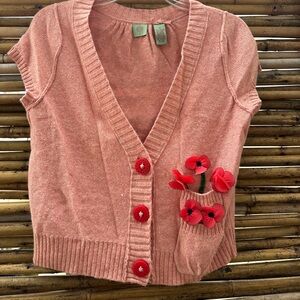 Cute little pink short sleeve sweater with a pocket of poseys. Size medium